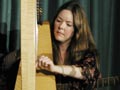 Ariane Lydon on the 12-string guitar & 36-string harp